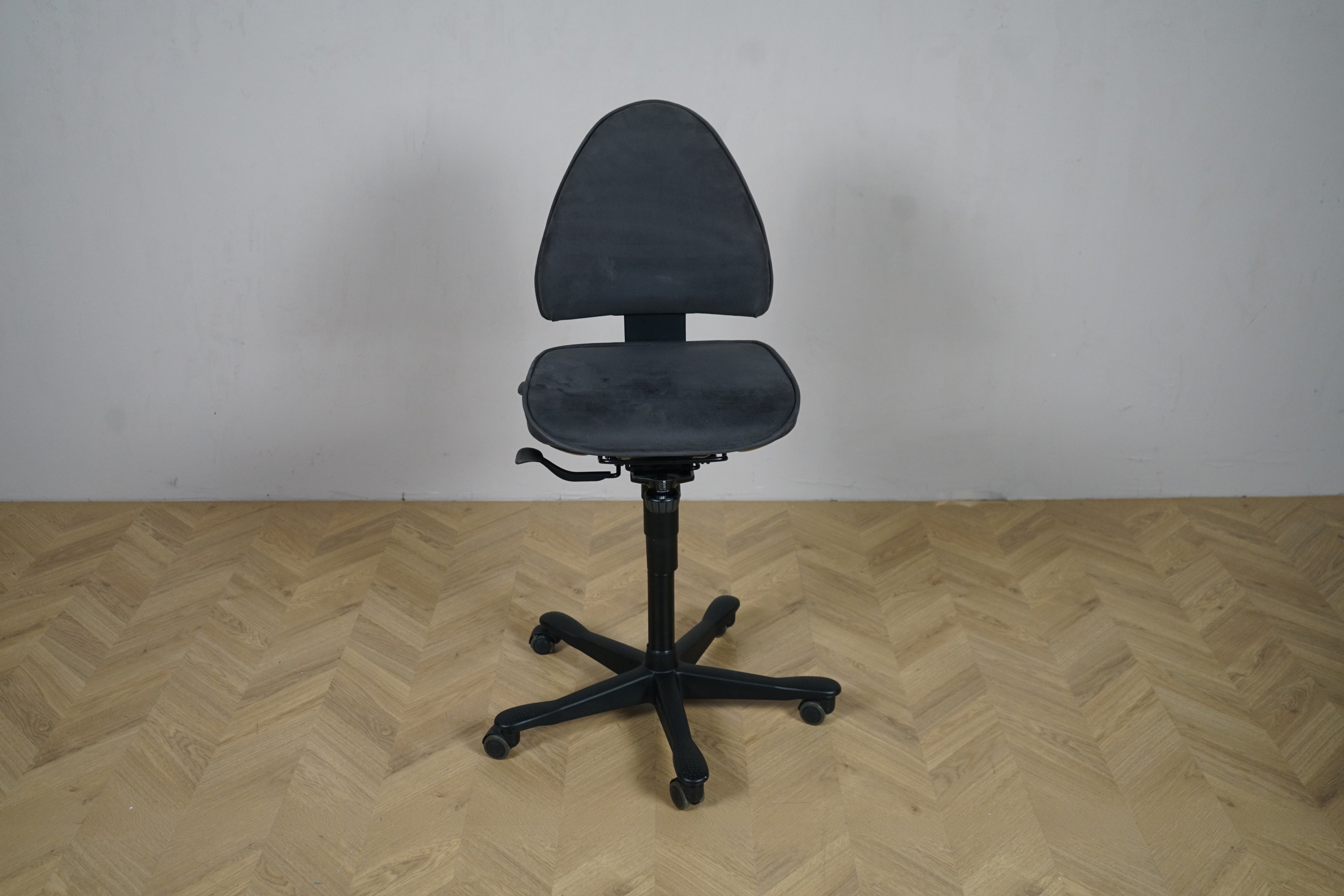 Kinnarps Free Float 6000 kontorstol set forfra i mørkegrå alcantara med sorte ben og hjul